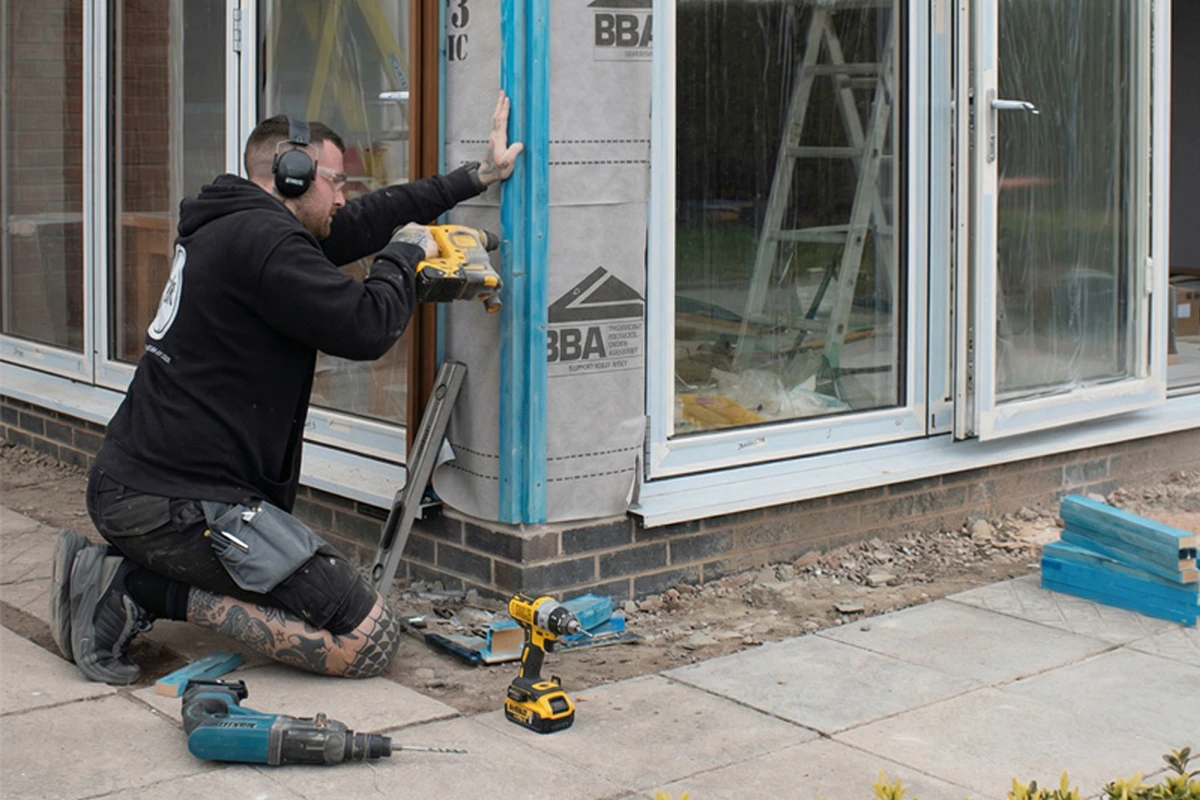 Carpenter fixing battens on a house extension as site carpentry work evidence