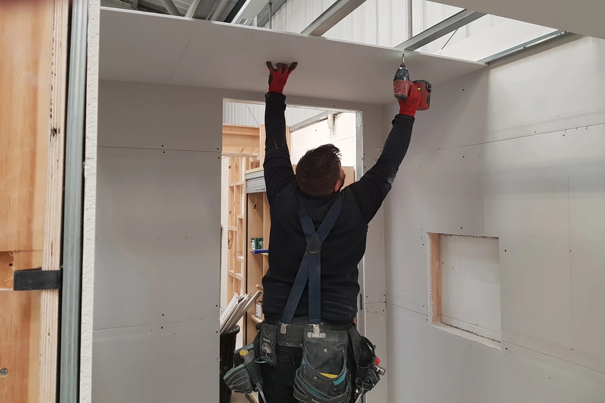 Ceiling Fixer Placing Board In Position Using Screws